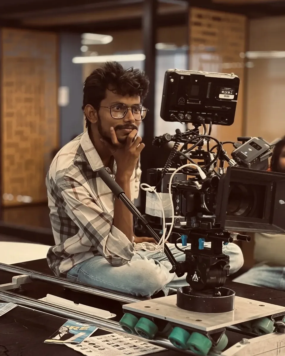 Akhil K on set behind a cinema camera